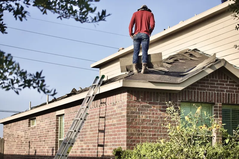 Professional roofer working on a residential roof in Central